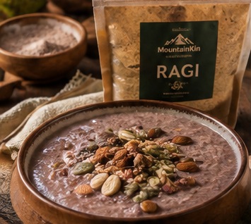 Ragi porridge topped with nuts and seeds in a wooden bowl